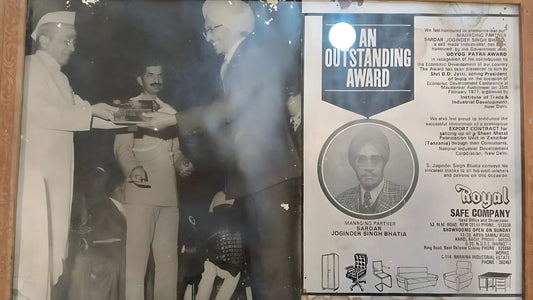 Black and white photo of Sardar Joginder Singh Bhatia receiving an Outstanding Award with company details and furniture illustrations